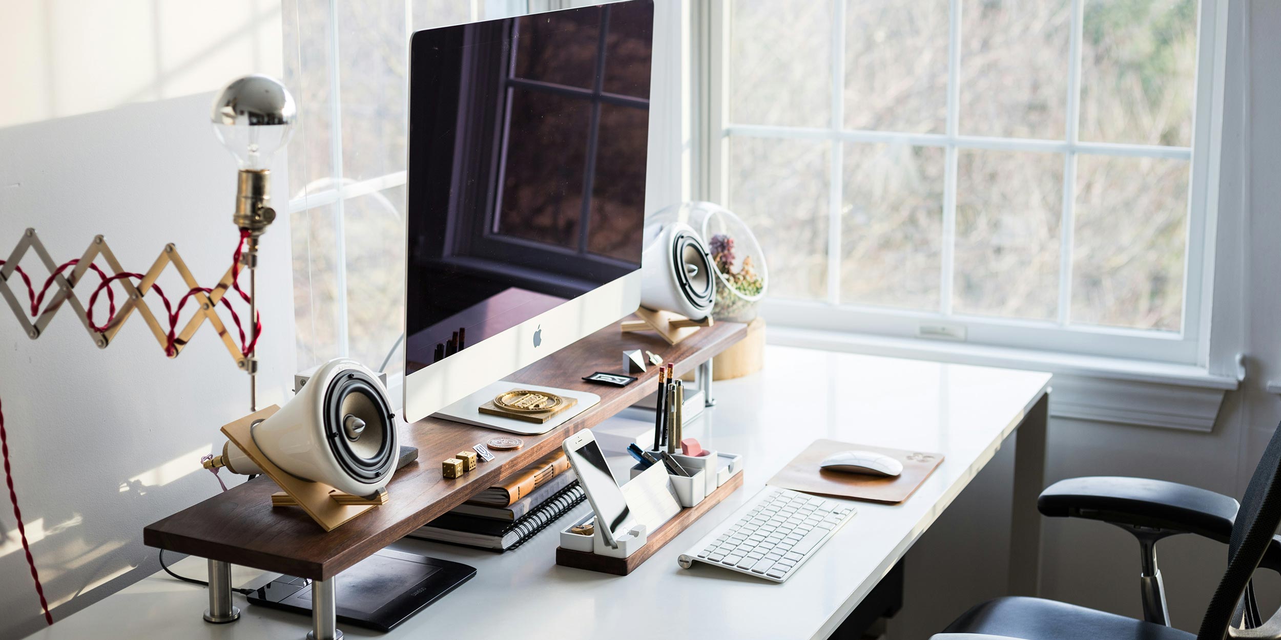 Stylish home office setup with a large computer and high-quality speakers