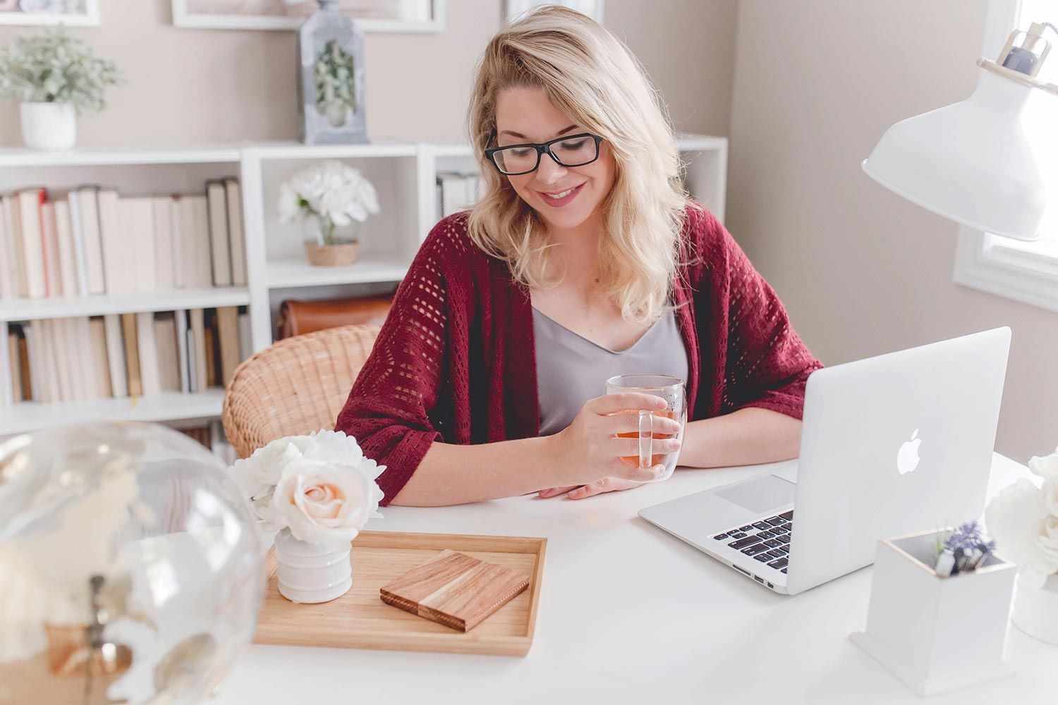 Woman working on a laptop in a cozy home office