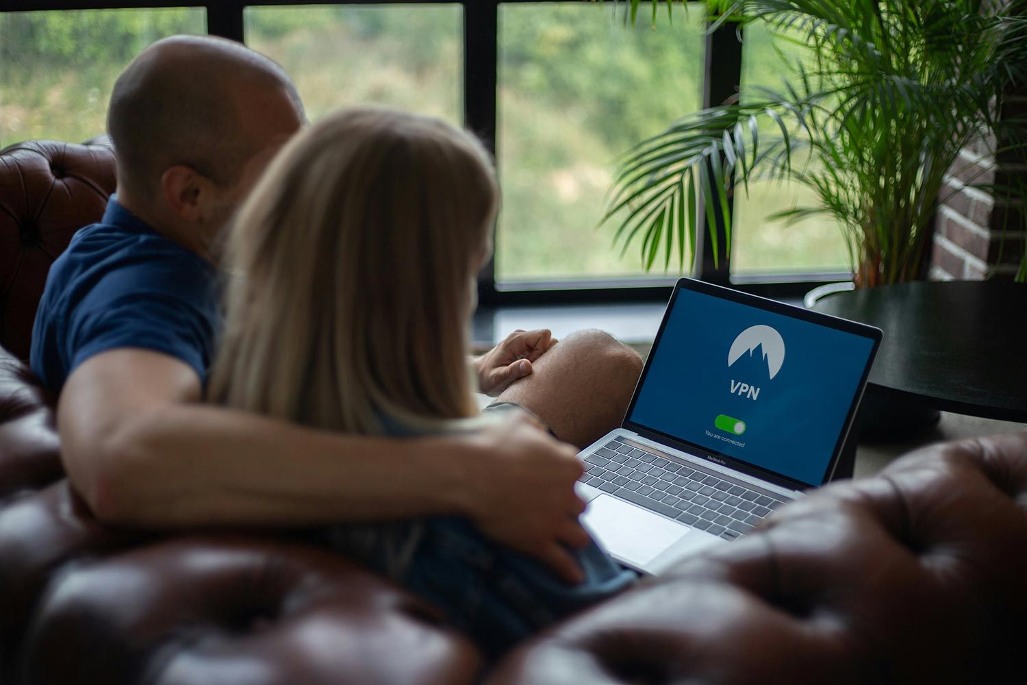Couple using a laptop with a VPN connection screen