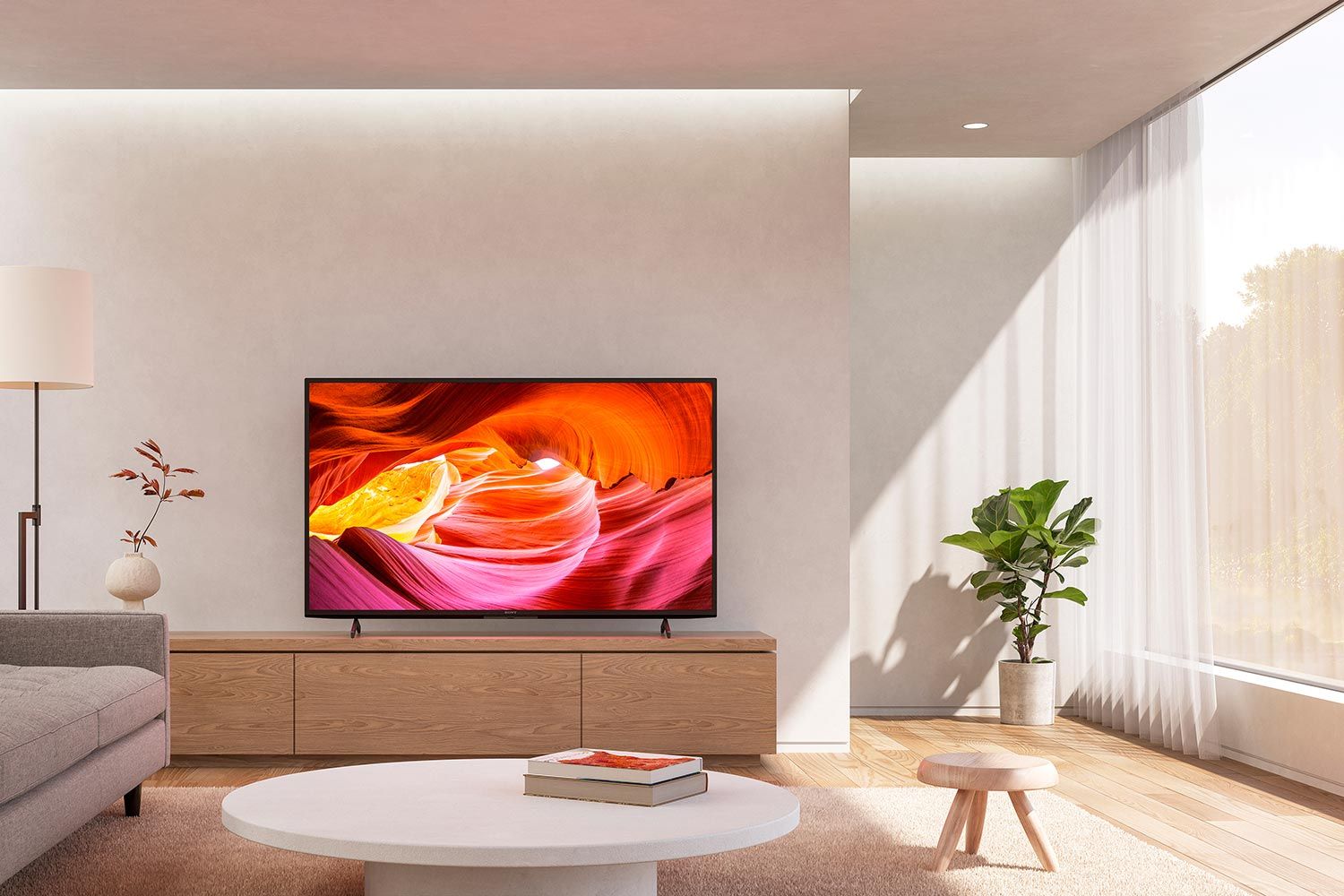 Minimalist living room with a large TV and natural light