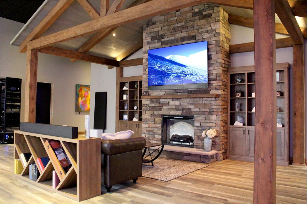 Stylish open-concept showroom with large TV, audio equipment, and wall art