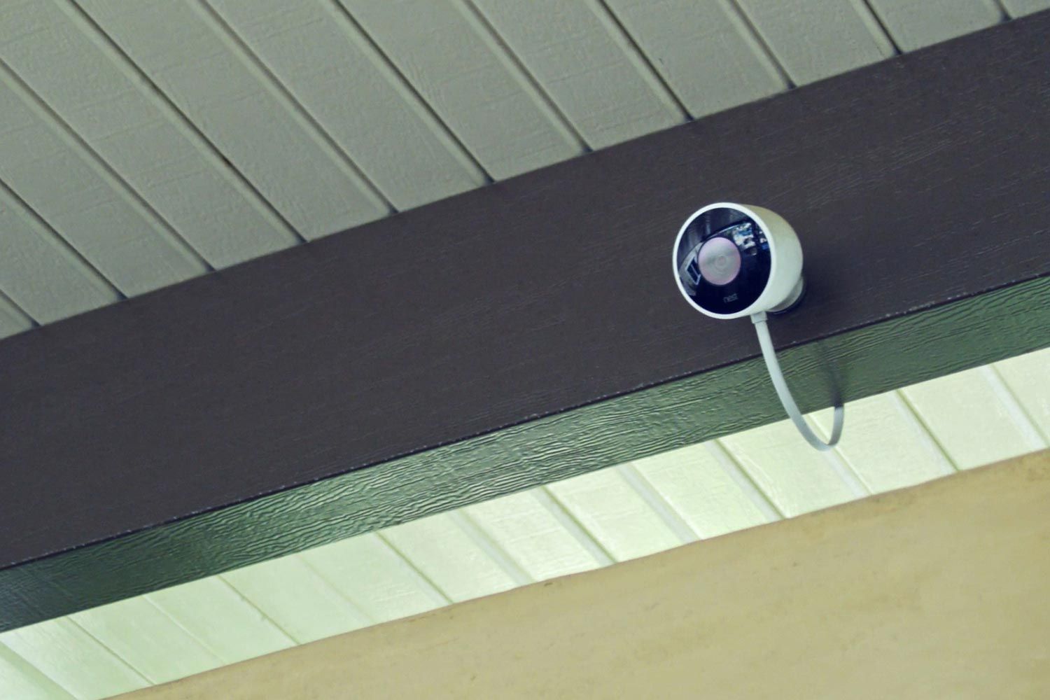 Outdoor security camera mounted under a roof beam