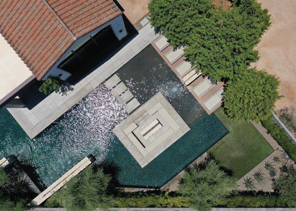 Aerial view of a modern home with an intricate water feature design