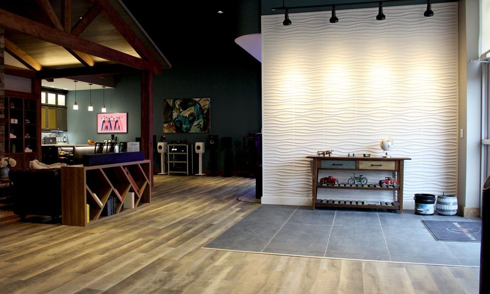 Entry area of showroom with white textured wall and rustic wood table