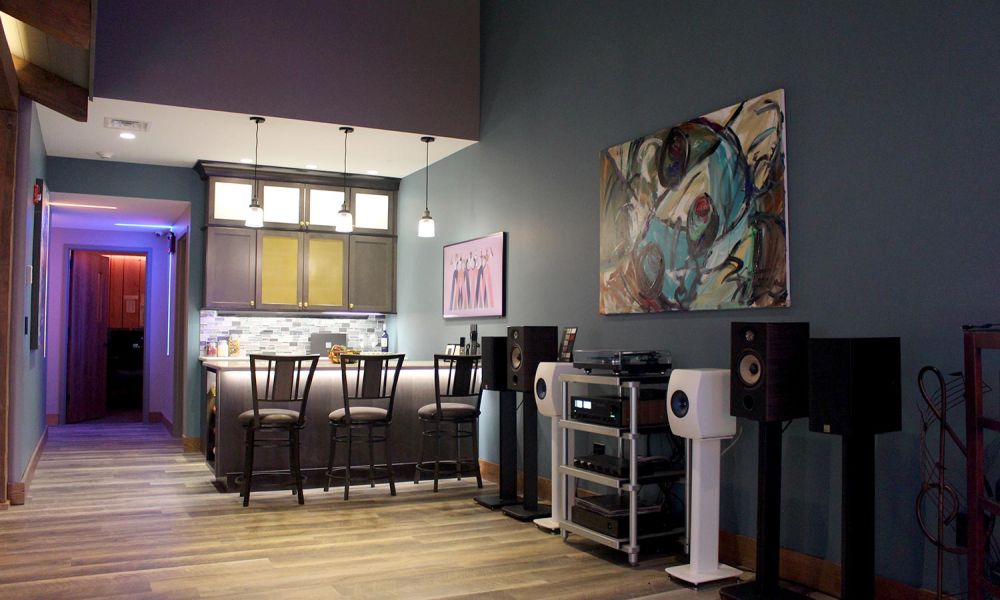 Home bar area with pendant lights, stools, and high-end audio equipment