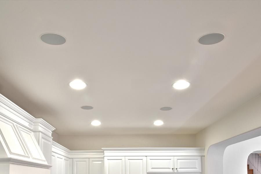 Kitchen ceiling with round recessed lights and speakers