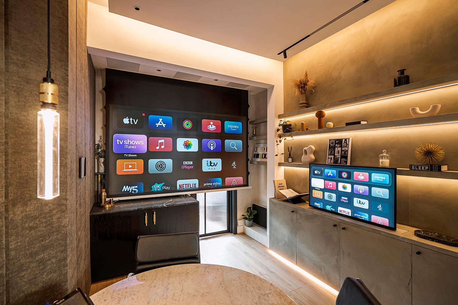 Modern room with multiple smart TVs displaying apps