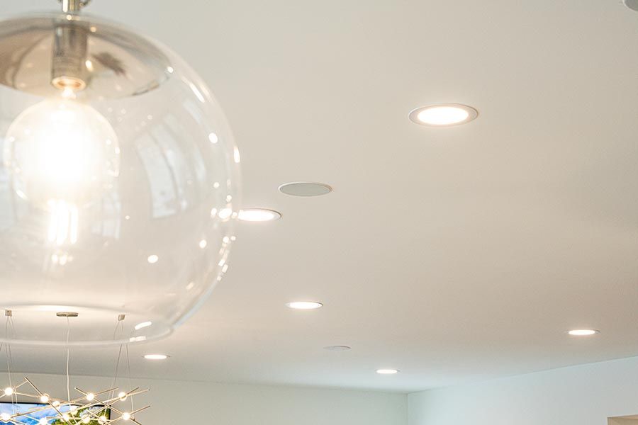 Close-up of ceiling with recessed lighting and integrated speakers