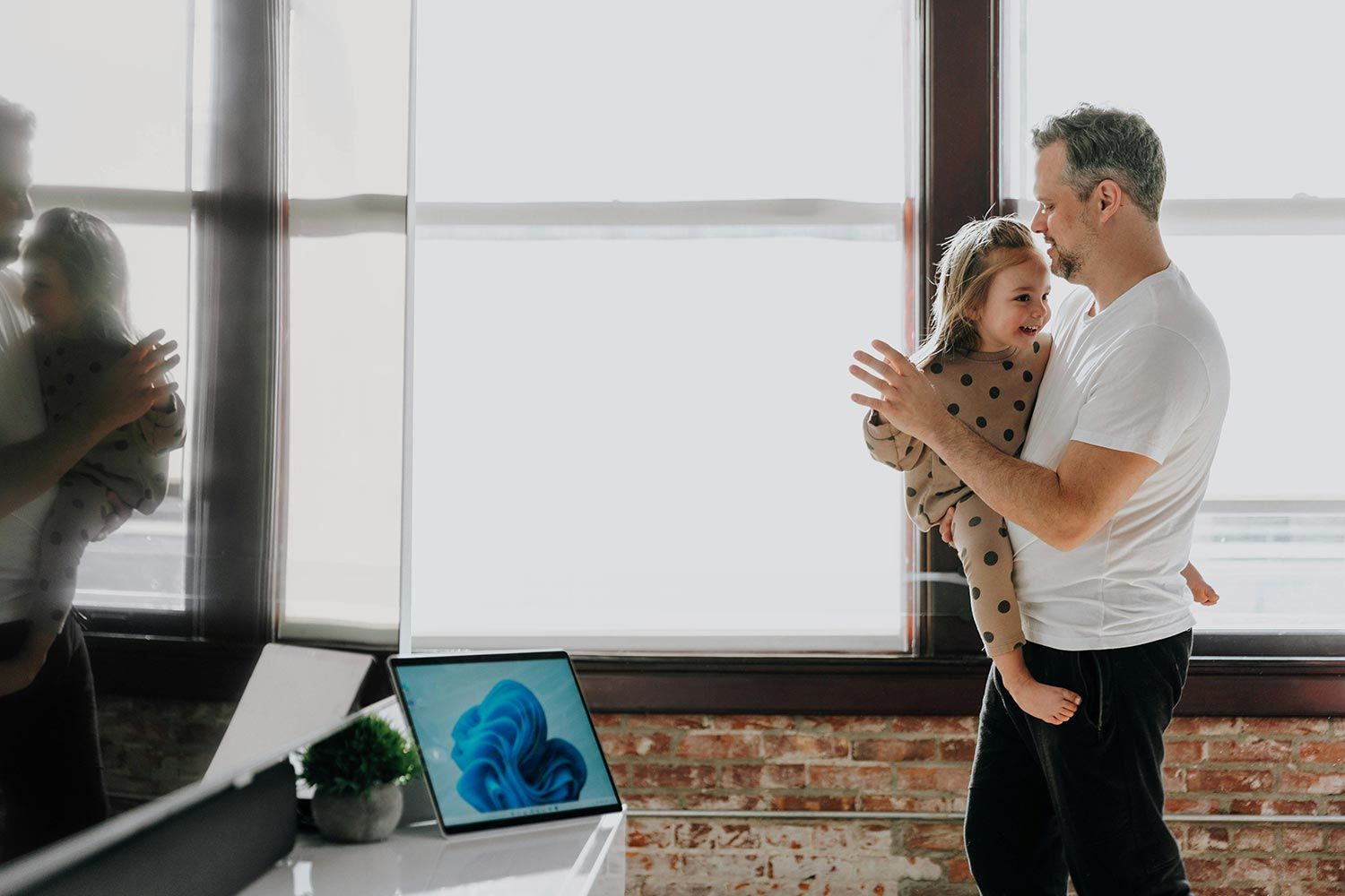 Father holding daughter in a bright modern home