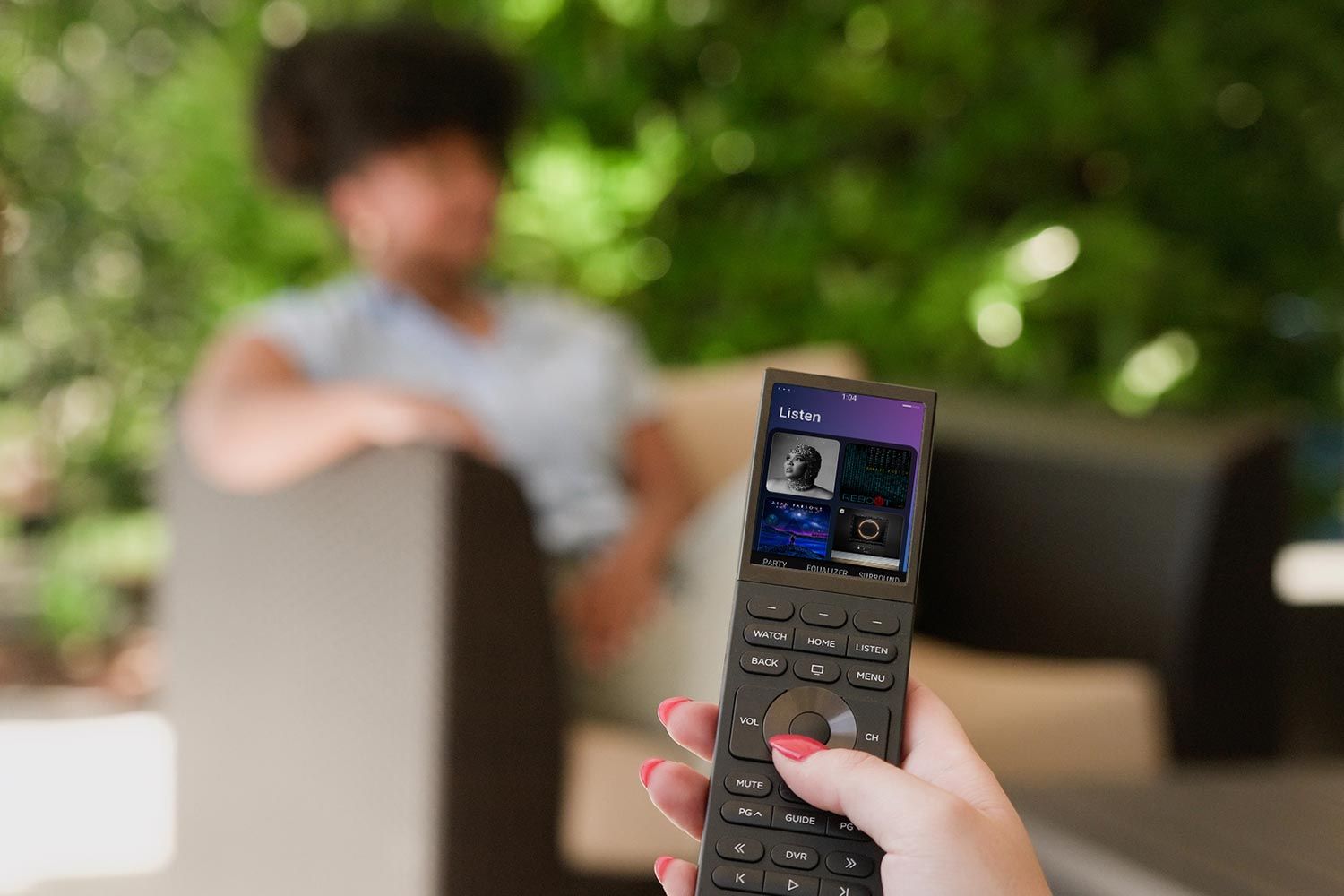 Person holding a smart remote control outdoors