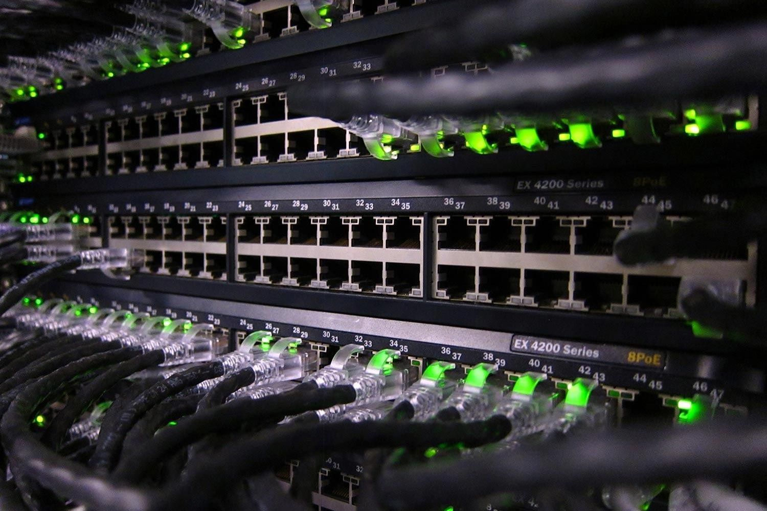 Close-up of network switches with glowing green indicator lights
