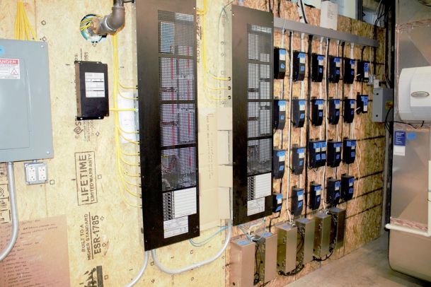 Wall of structured wiring and control panels for a residential automation system