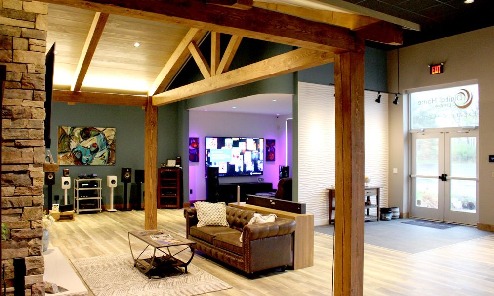 Stylish open-concept showroom with large TV, audio equipment, and wall art