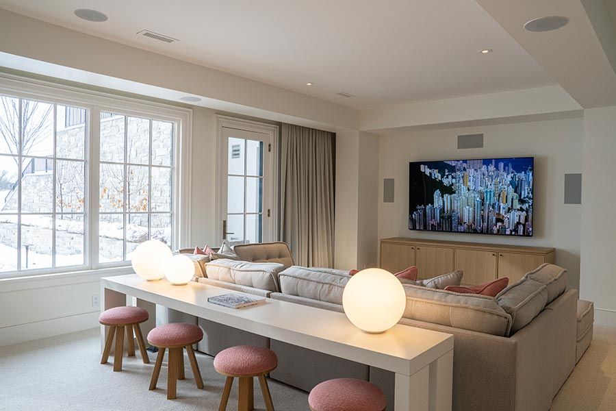 Cozy home theater with a large TV and modern seating
