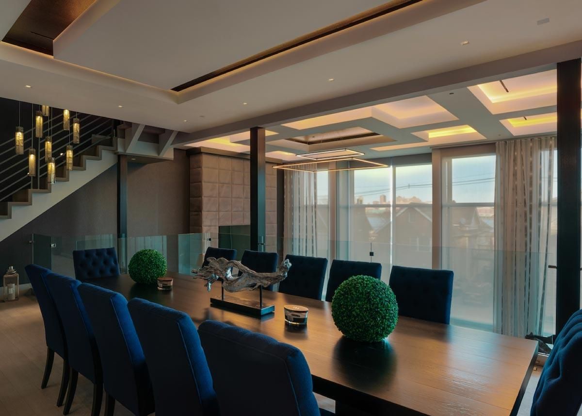 Stylish dining room with deep blue chairs and elegant lighting